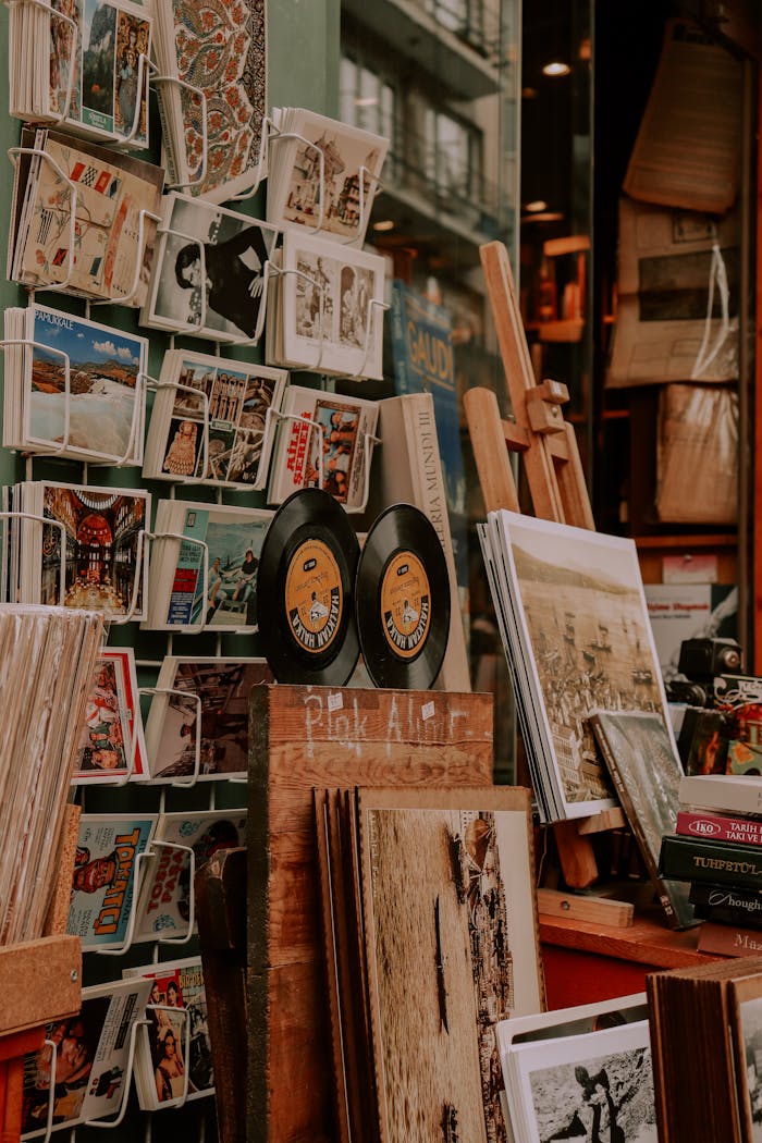 Charming display of vinyl records, art prints, and postcards at a vintage store.