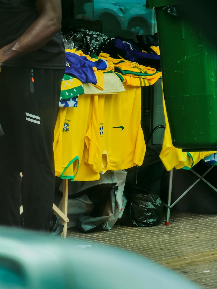 A vibrant display of Brazilian football jerseys on a street vendor's stand, perfect for sports fans.